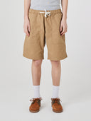 Bottom-half front view of male model wearing khaki 5024 men's ripstop utility shorts with clear view of deep utility front patch pockets.