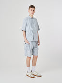 Full-length view of male model wearing Uskees 5026 pale blue-grey Technique trekking shorts with a matching Uskees shirt.