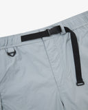 Close-up front view of pale blue-grey Technique trekking shorts for men showing the elasticated waist, triangle carabiner and built-in belt.