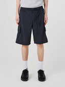 Bottom-half view of model wearing Uskees 5026 black Technique trekking shorts indicating relaxed fit.