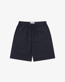 Front flat shot of Uskees dark blue shorts for men. Clear view of drawstring, elasticated waist and Uskees branding label.