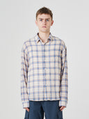 Front view of a male model wearing an Uskees blue pebble plaid lumberjack shirt for men.