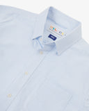 Close up view of Uskees light blue and white striped men's Oxford shirt with focus on collar and Uskees brand label.