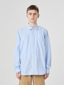 Upper body view wearing Uskees light blue men's Oxford shirt.
