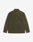 Reverse view of the dark 'Pennine' green Uskees wax storm jacket showing the boxy silhouette, Halley Stevenson dry wax fabric, hanging loop and adjustable hem.