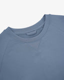 Close-up view of crew neck collar with decorative v-insert on Uskees cornflower blue heavyweight cotton jersey sweatshirt.