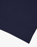 Closer view view of the discreet brand logo on ribbed hem of the Uskees deep indigo organic heavyweight cotton 7005 jersey sweatshirt.