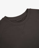 Close-up view of crew neck collar with decorative v-insert on Uskees faded black heavyweight cotton jersey sweatshirt.