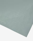 Hem close-up of the green-grey 'steel' coloured organic cotton T-shirt showing texture of the medium weight organic cotton jersey.