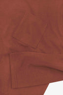 Closer look at the chest pocket and cuff of the chestnut brown organic cotton long sleeve T-shirt showing texture of the medium weight organic cotton jersey.