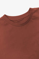 Neckline close-up of Uskees chestnut brown organic cotton long-sleeve T-shirt showing hanging loop.