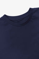 Neckline close-up of Uskees dark indigo organic cotton long-sleeve T-shirt showing hanging loop.
