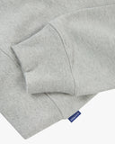 Front flat close up shot of Uskees grey marl Champ Sweatshirt for men showing the ribbed hem, cuff detail and Uskees branding label tab.