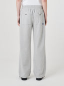 Back view of model wearing Uskees 7012 gray marl sweatpants with a white t-shirt.