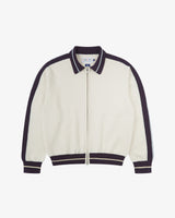 Front flat view of an Uskees cream bomber jacket with purple accents on a white background.