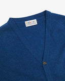 Front view of Uskees admiral blue lambswool Harris cardigan with focus on v-neck, corozo buttons and branding label.