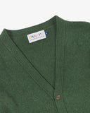 Front view of Uskees moss-green lambswool Harris cardigan with focus on v-neck, corozo buttons and branding label.