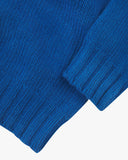 Close up shot of Uskees ultra blue roll neck sweater for men showing the ribbed cuff and hem detail.