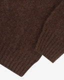 Close up view of Uskees 7021 Skye lambswool sweater in brown, with focus on the wool texture, hem and cuff.
