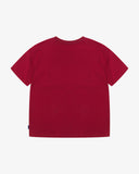Back view of the Uskees red organic cotton jersey T-shirt showing the loose silhouette.