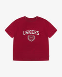 Full flat view of the Uskees red organic cotton T-shirt for men, showing the brand graphics on front and loose silhouette.