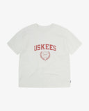 Full flat view of the Uskees white organic cotton T-shirt for men, showing the brand graphics on front and loose silhouette.