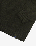 Close up of an Uskees green/brown speckled men's sweater showing the cuff and welt detail.