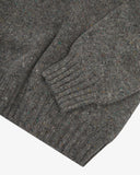 Close up of an Uskees speckled grey men's sweater showing the cuff and ribbed welt detail.