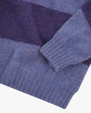 Close up shot of Uskees violet and purple striped sweater for men showing the cuff and welt detail.
