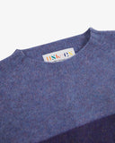 Close up shot of Uskees violet and purple striped sweater for men showing the neck detail including the brand label.
