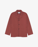 Chestnut-brown buttoned organic cotton-drill blazer from Uskees with clear view of three patch pockets and Uskees branding label.