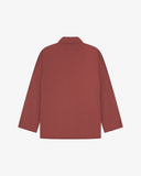 Reverse of chestnut-brown buttoned organic cotton-drill blazer from Uskees showing reinforced elbows and boxy silhouette.